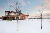 Exterior design of new residential two storey house with modern stone and wooden facade.