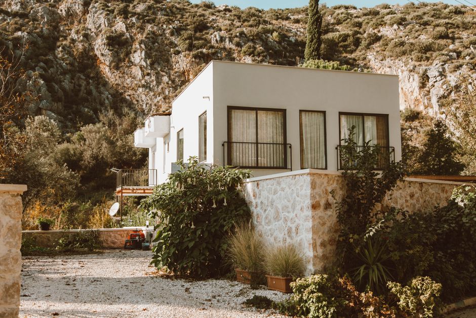 Contemporary house in sunlit rocky outdoor setting