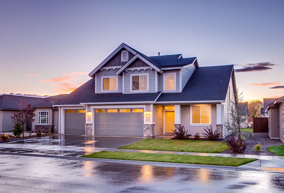 Elegant suburban home with driveway at sunset