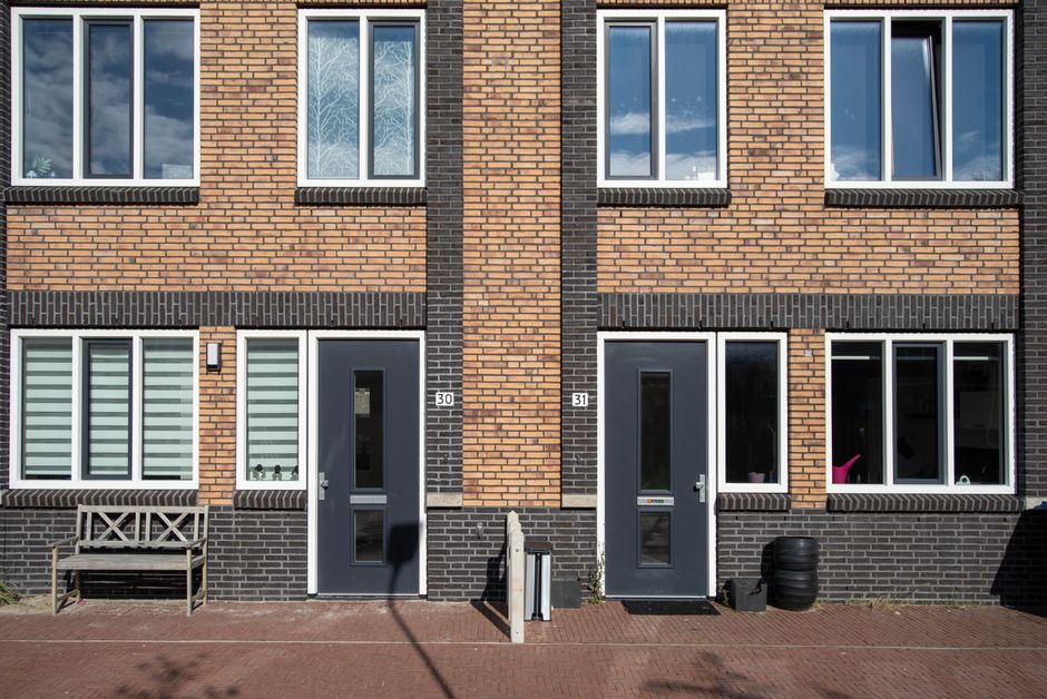 Modern brick house facade with large windows