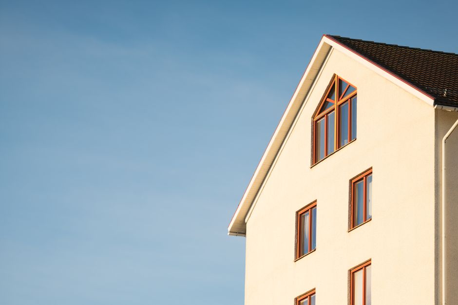 Minimalist modern residential building facade against clear blue sky